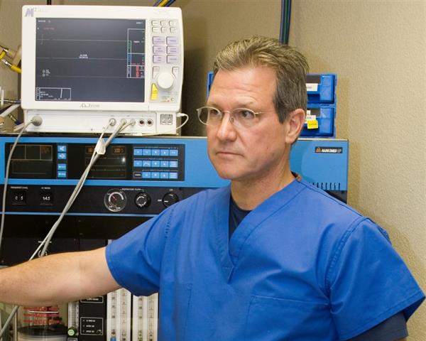 James Geiger MD next to old Drager anesthesia machine