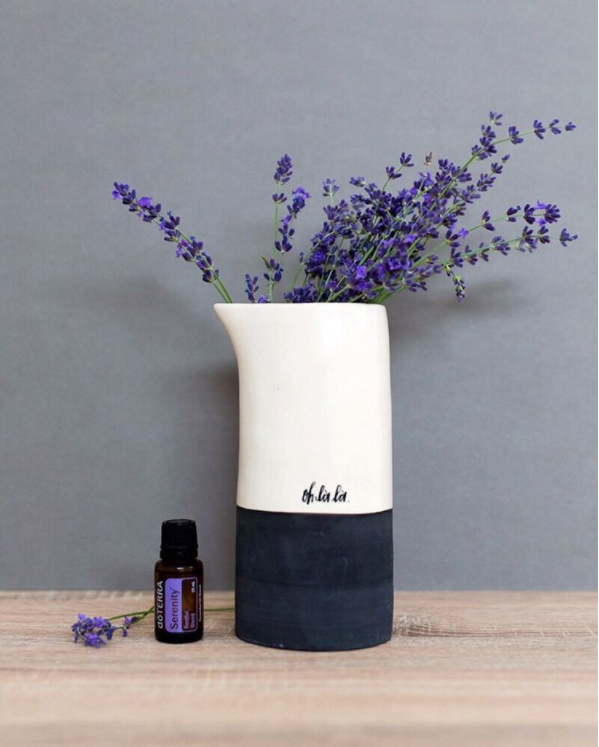 Serenity blend of essential oils for sleep with vase of blue flowers